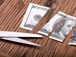 100 dollar bill cut up with scissors