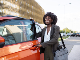 Businesswoman getting into car
