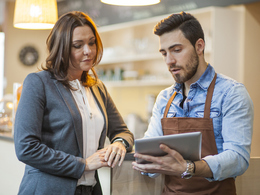 Two professionals reviewing tablet